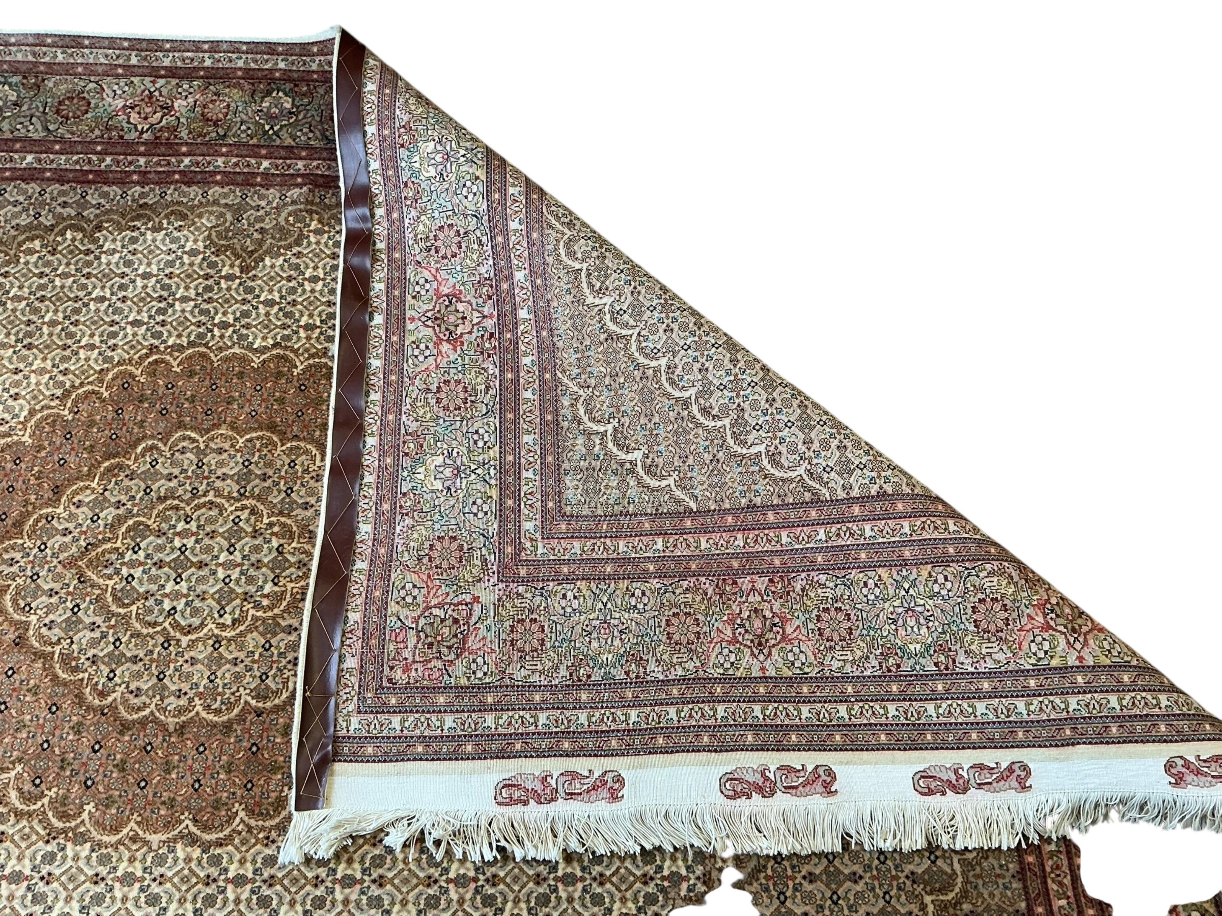 A North West Persian ivory ground rug, 245 x 170cm
